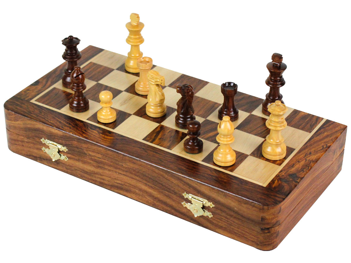 Folded chess board with chess pieces on top