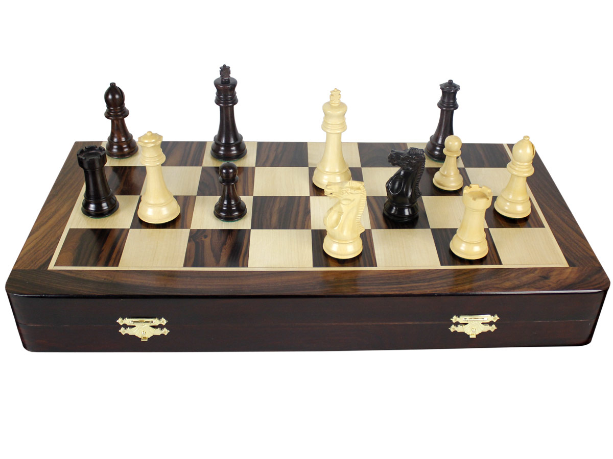 Front view of chess set with pieces on top of board
