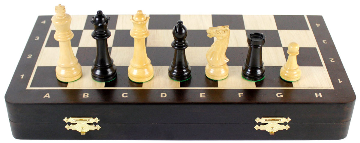 Front view of chess set with pieces on top of board