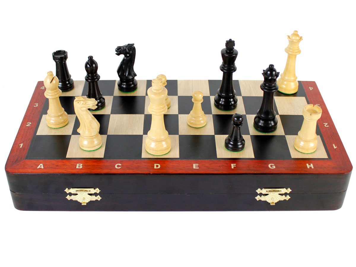 Front view of chess set with pieces on top of board