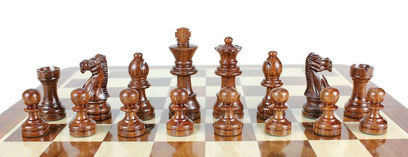 Golden Rosewood Chess Pieces on the Chess board