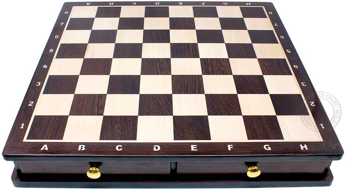 Chess pieces placed in foam cut outs inside the drawers.