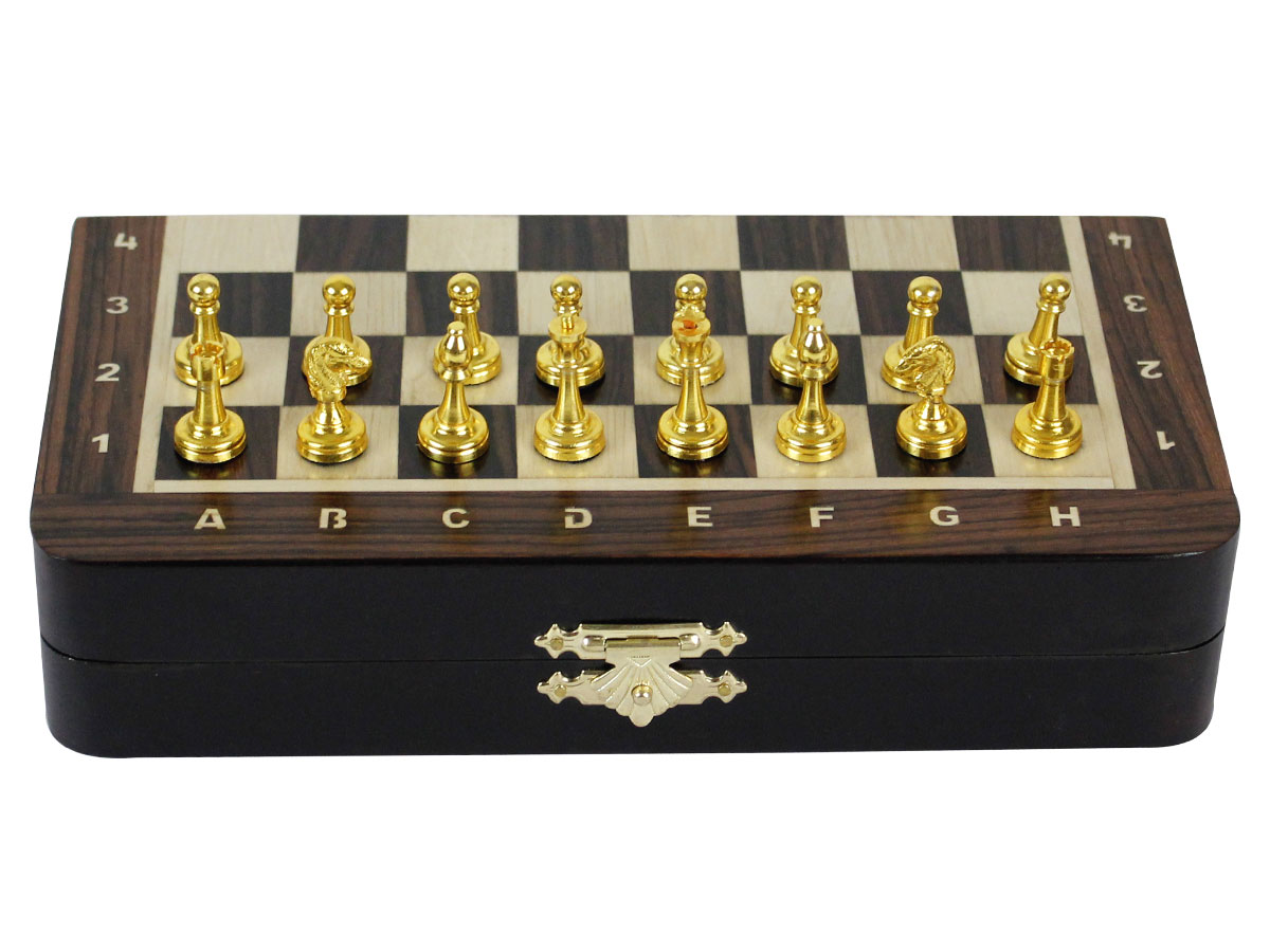 Front view of closed chess board with metal pieces on top
