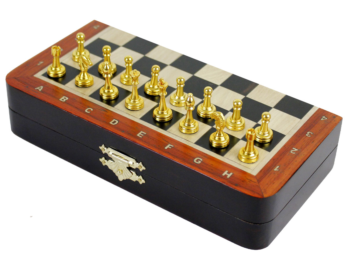 Side view of closed chess board with metal pieces