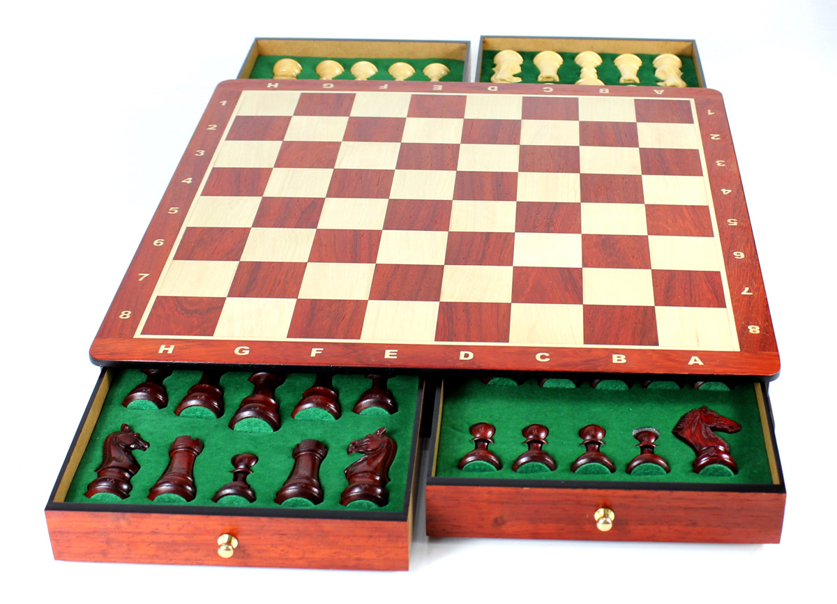 Chess pieces placed in foam cut outs inside the drawers.